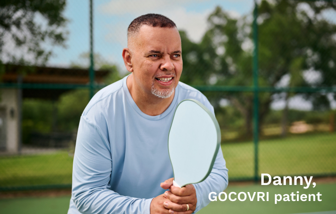 Danny, a GOCOVRI patient, ready to receive a serve while playing pickle ball. 